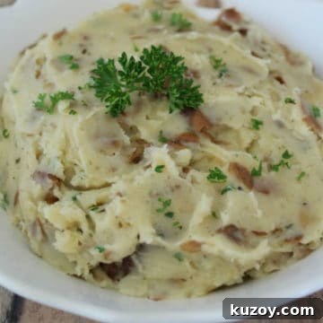 Creamy Garlic-Herb Mashed Potatoes in a Crock Pot 3 garlic herb mashed potatoes in a white bowl