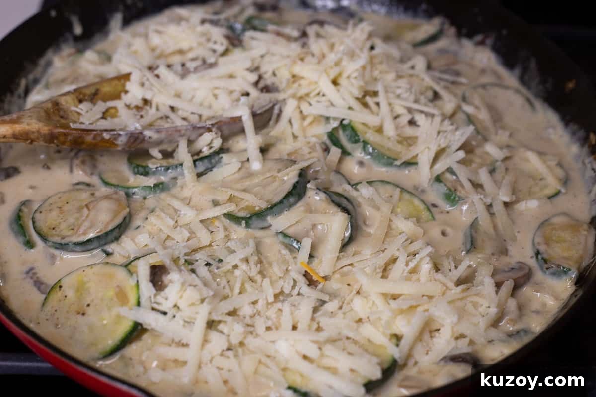 Baked Ravioli Alfredo Casserole with Creamy Parmesan Sauce 8 Freshly grated Parmesan cheese is added to skillet with cream sauce.