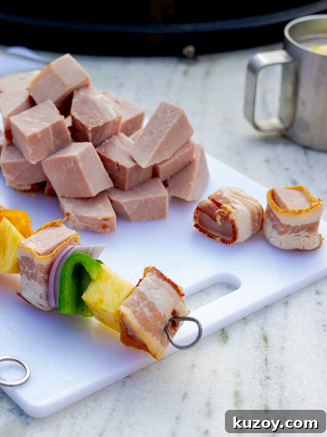 Grilled Bourbon Bacon, Ham & Pineapple Kabobs Recipe 5 raw ingredients for Bourbon Bacon Ham and Pineapple Kabobs on a skewer