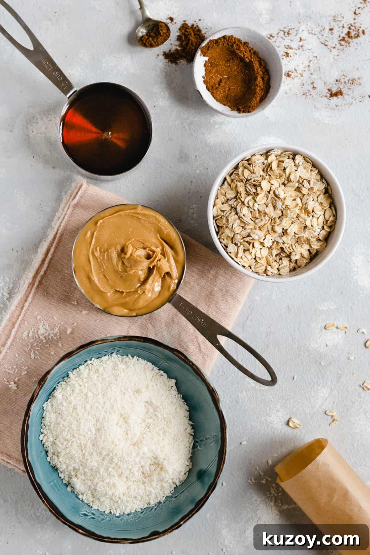 Coconut Peanut Butter Energy Bites with Warm Spices 2 Overhead shot of bowl of oats, shredded coconut, peanut butter, maple syrup and mixed spice