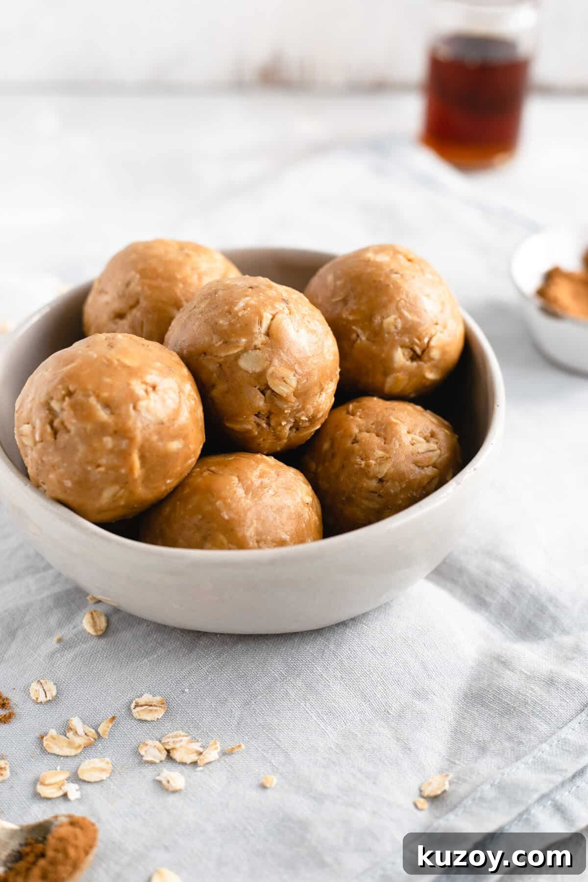 Coconut Peanut Butter Energy Bites with Warm Spices 7 Side shot of small bowl filled with coconut and peanut butter spiced energy bites