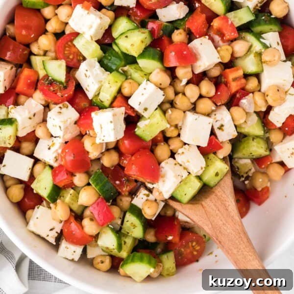 Asparagus Ribbon Salad with Beets and Creamy Burrata 7 Chopped greek salad with a wooden spoon.