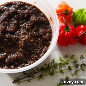 Authentic Jamaican Jerk Marinade Recipe for Chicken & Pork 6 Jerk marinade with peppers and thyme on the side.