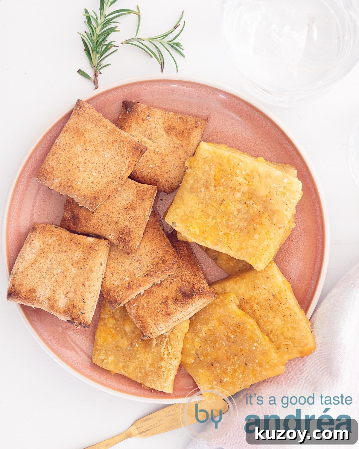 2 Crispy Homemade Cracker Bread Recipes You Can Bake Now 2 A photo from above with a pink plate with cheddar and herb toasts on a white background