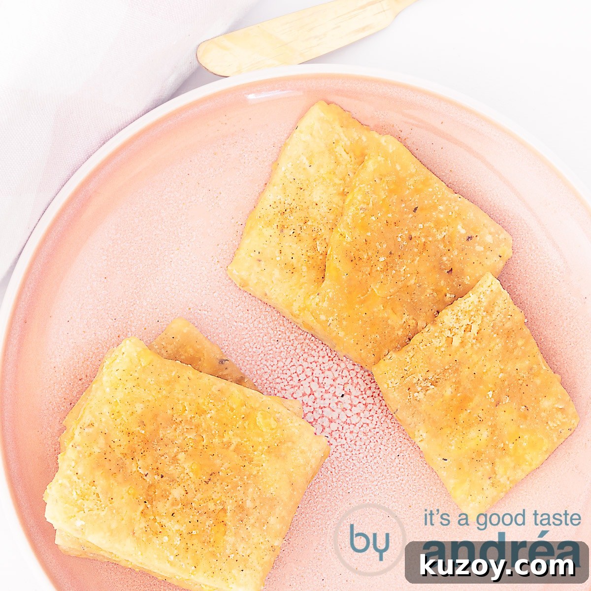 2 Crispy Homemade Cracker Bread Recipes You Can Bake Now 9 a square photo with a pink plate filled with cheddar cheese crackers
