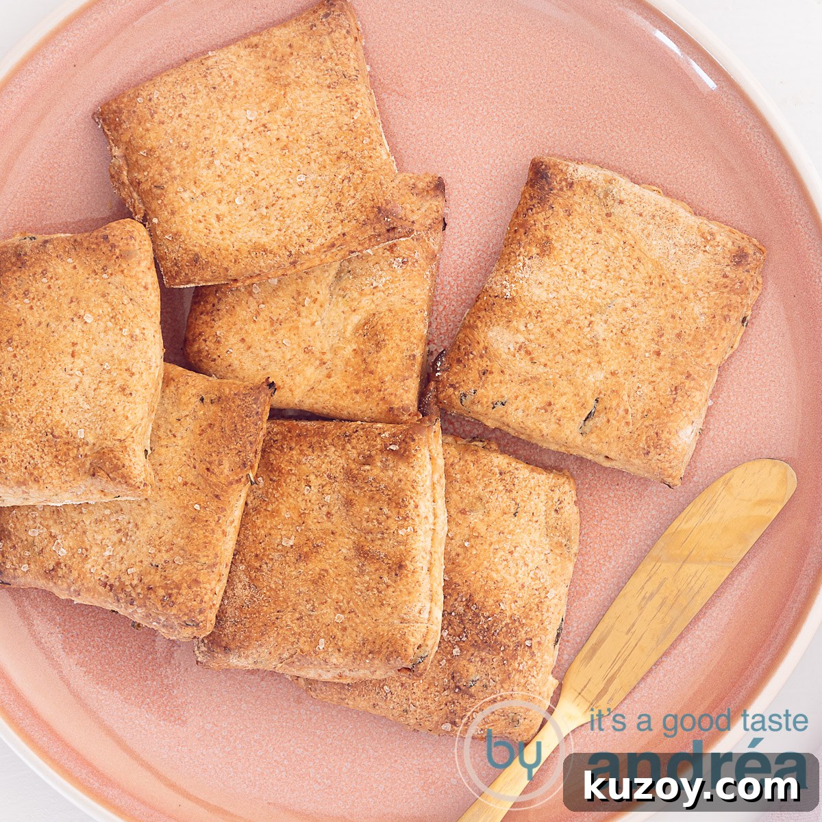 2 Crispy Homemade Cracker Bread Recipes You Can Bake Now 8 A pink plate on a white background filled with whole grain crackers with herbs