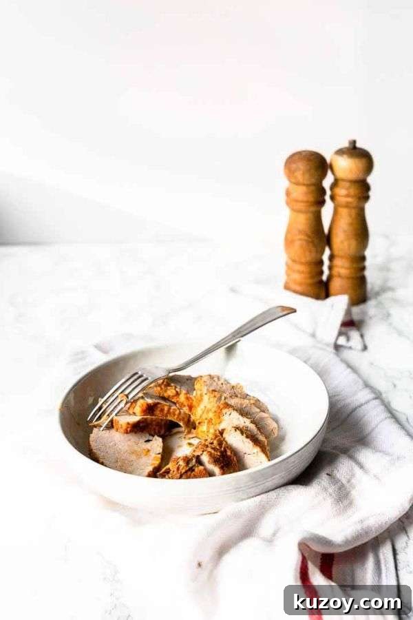 Instant Pot Pork Tenderloin: Juicy, Quick Weeknight Recipe 8 Pork tenderloin served in a white bowl with a fork.