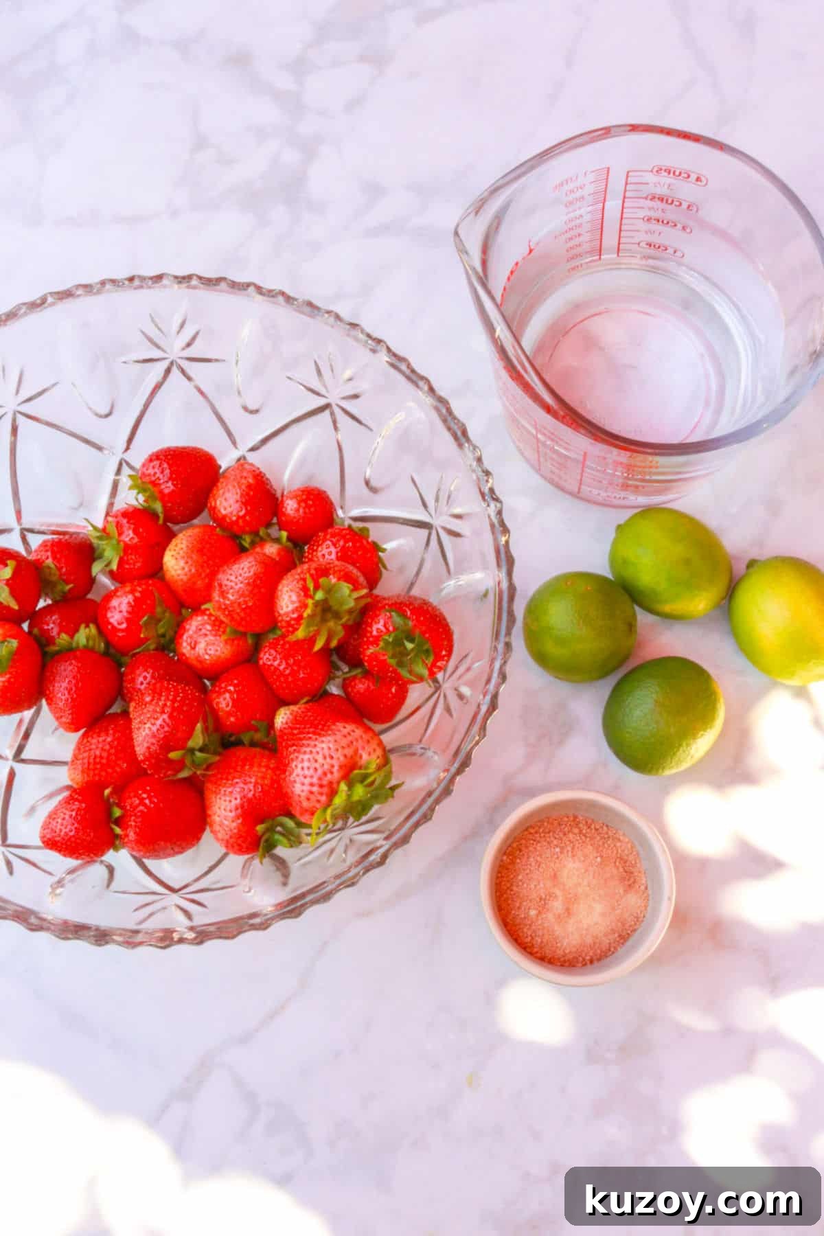 Refreshing Strawberry Limeade Recipe: Homemade Strawberry-Lime Cooler 3 Bowl of strawberries, a measuring cup with water, limes and a bowl with coconut sugar for strawberry limeade