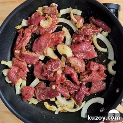 Marinaded beef added in pan for stir fry