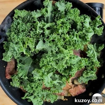 kale leaves added to pan