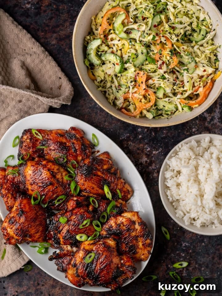 Asian Cucumber Slaw with Tangy Sweet Chili Dressing — Fresh Crunch and Zing 8 white platter of miso chicken thighs, large bowl of Asian cucumber slaw, small bowl of rice