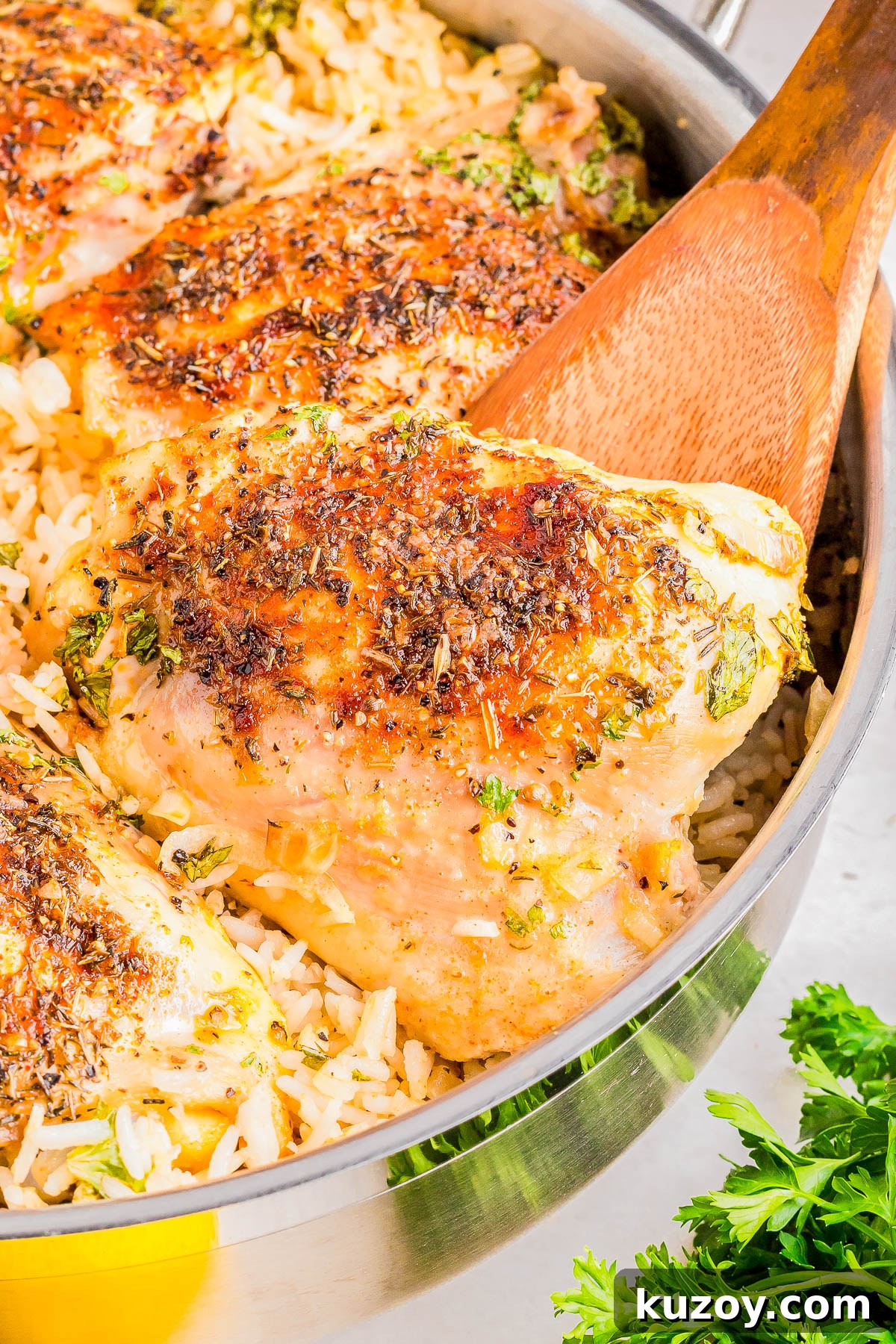 Chicken thighs seasoned and baked over rice in a skillet.