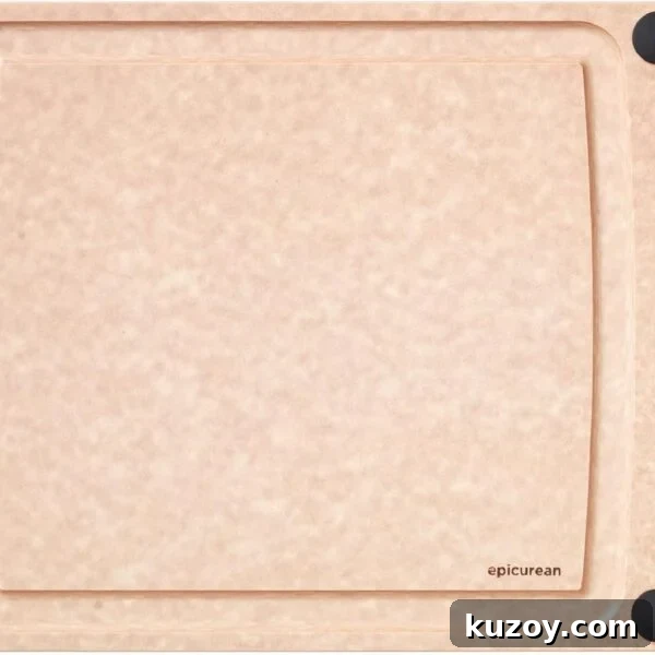 A rectangular, light brown cutting board with a smooth surface, four black non-slip corners, and a small hole on the left side. The brand name epicurean is printed in the lower right corner.