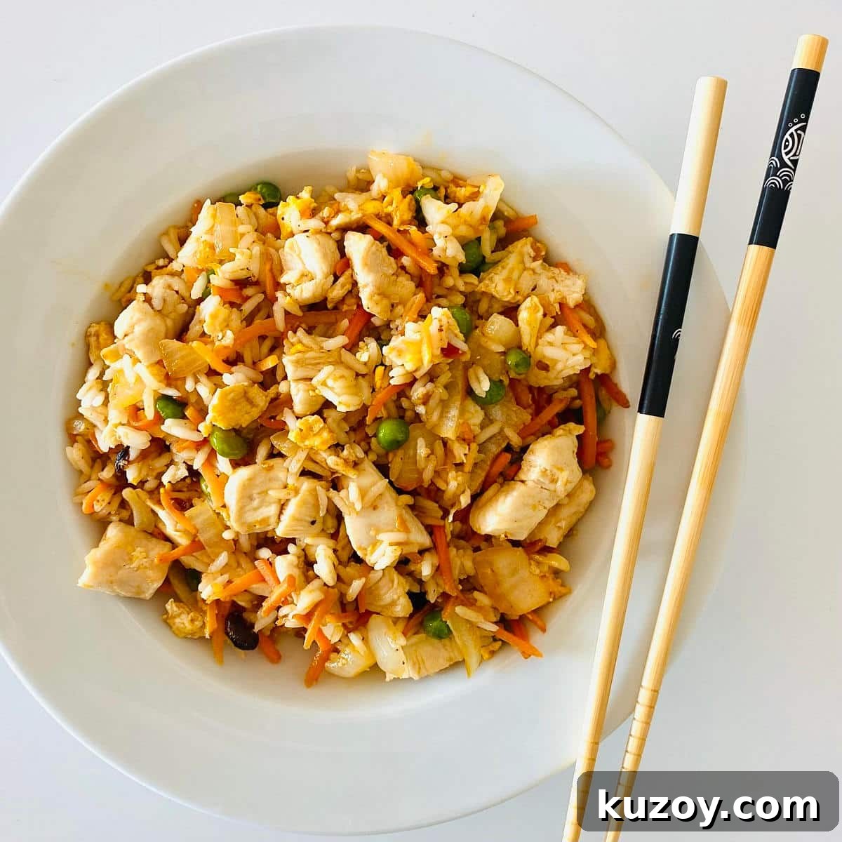 Blackstone-Style Fried Rice Recipe: Restaurant Flavor at Home 4 griddle fried rice in bowl with chopsticks.