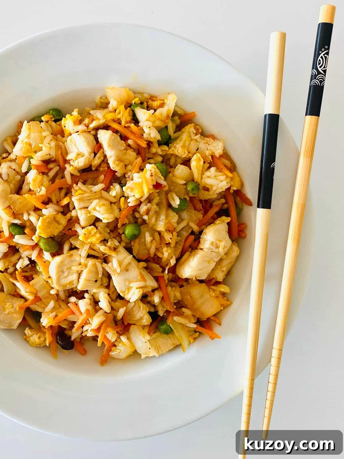 Blackstone-Style Fried Rice Recipe: Restaurant Flavor at Home 8 blackstone hibachi recipe in bowl with chopsticks.
