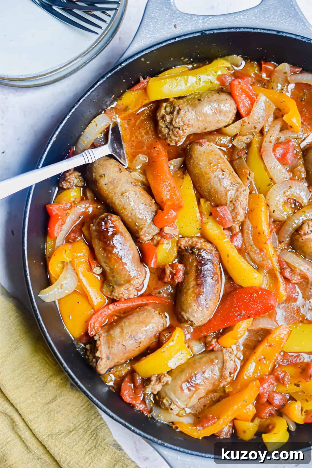 One-Pan Sausage and Peppers Recipe for Quick Weeknight Meals 11 A close up shot of the one pot sausage and peppers with a fork in the pan.