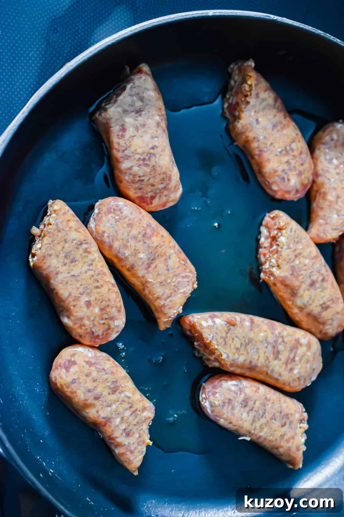 One-Pan Sausage and Peppers Recipe for Quick Weeknight Meals 4 The sausages are added to the pan.