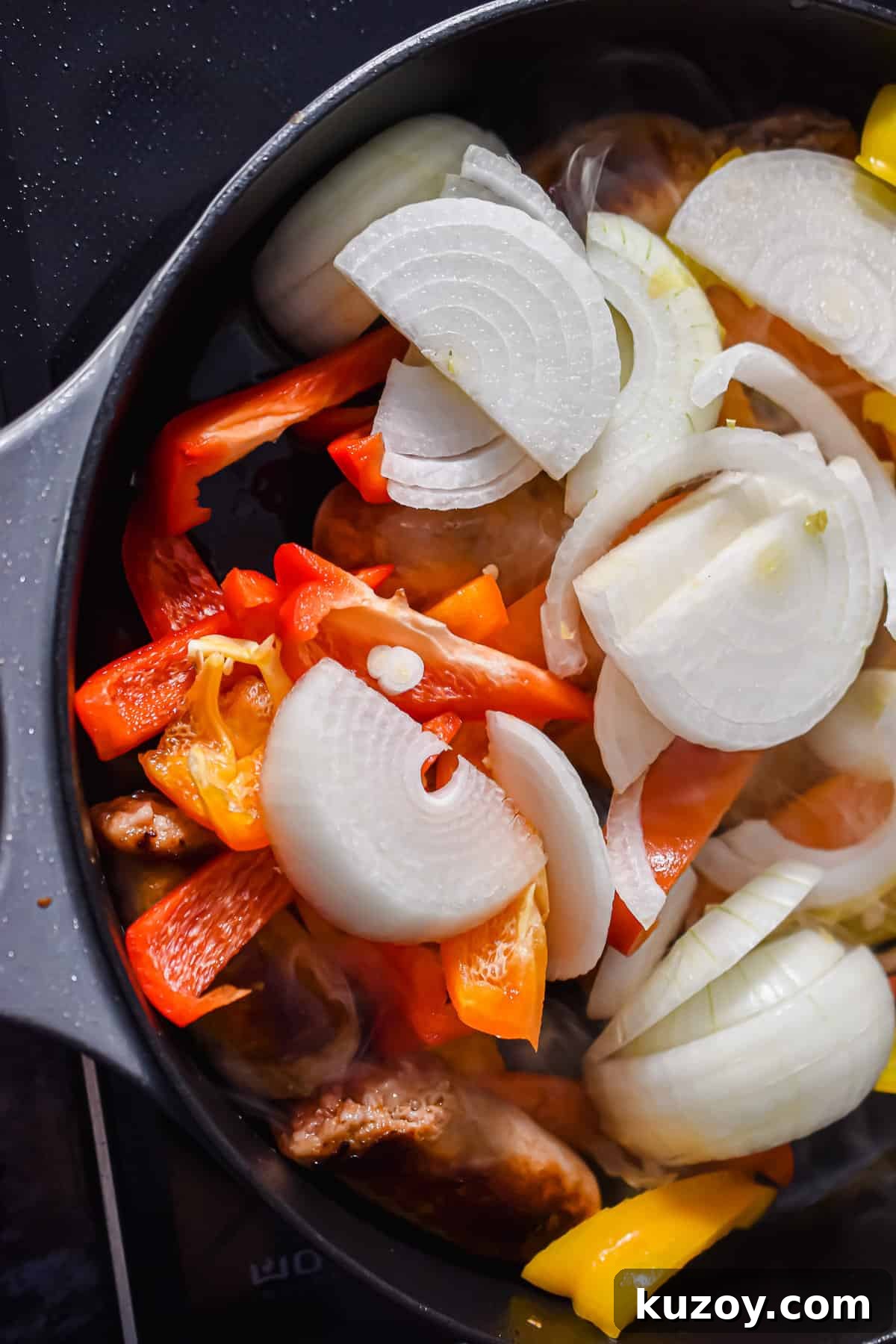 One-Pan Sausage and Peppers Recipe for Quick Weeknight Meals 7 The peppers and onions are added to the pan.