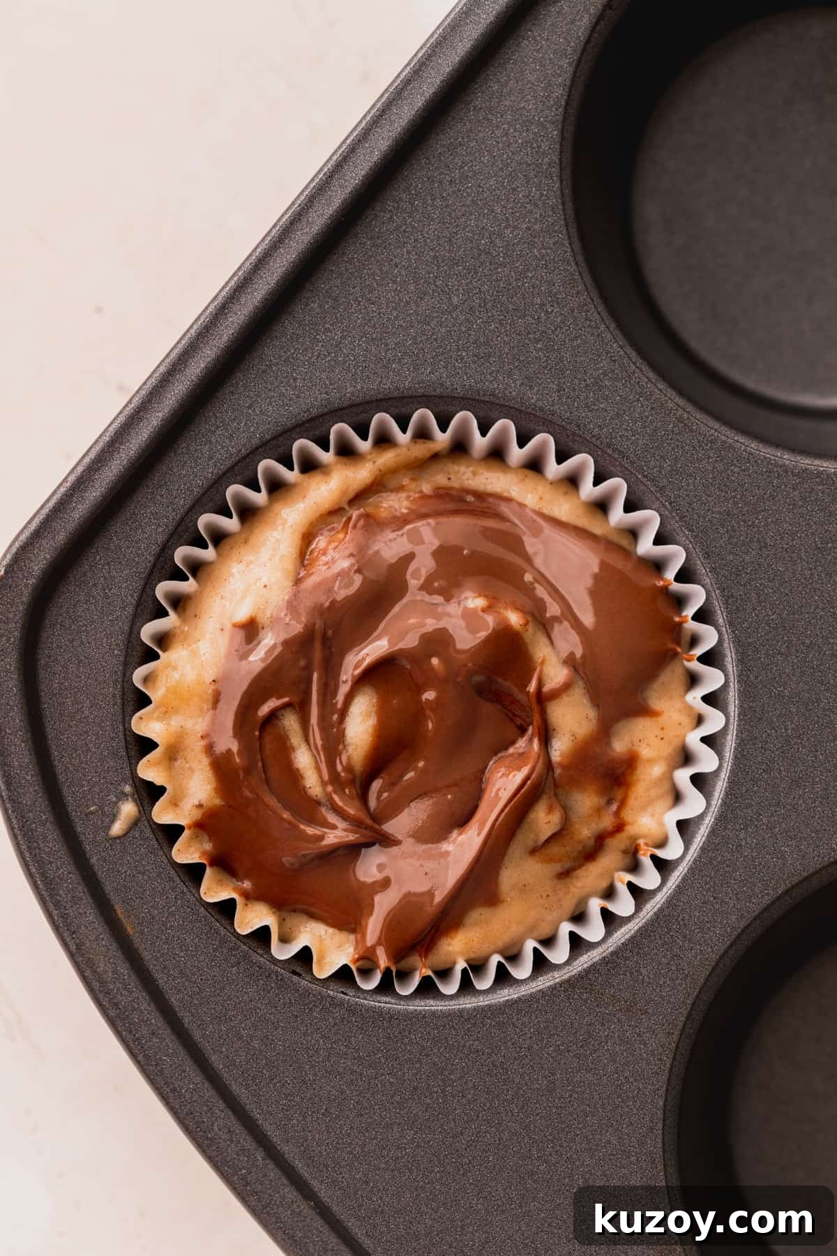 Nutella Banana Muffins Recipe — Gooey Chocolate Banana Muffins 9 Nutella swirled on top of the banana bread batter.