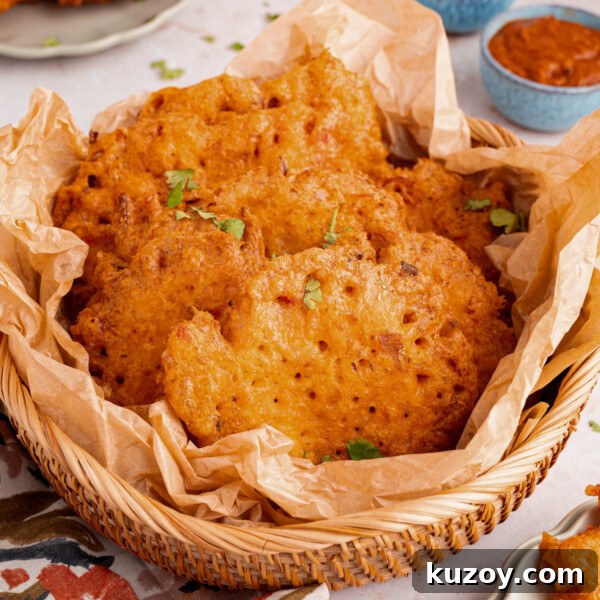 A basket filled with bacalaitos (or codfish fritters) sits on a countertop with napkins.