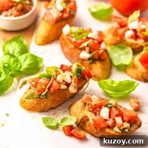 sliced bread topped with bruschetta and mozzarella.