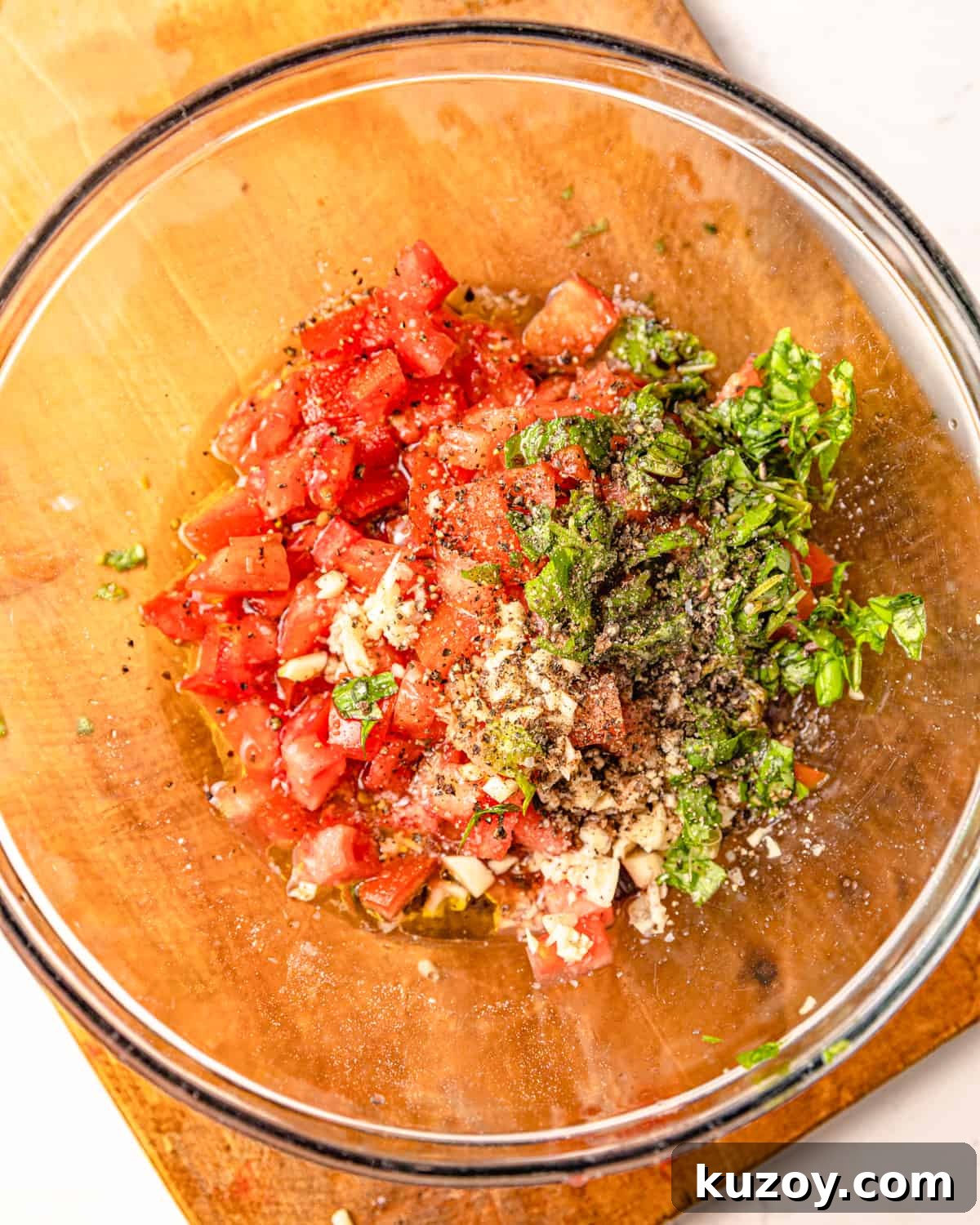 diced tomatoes, basil, garlic, salt, pepper, and balsamic vinegar and olive oil in a bowl.