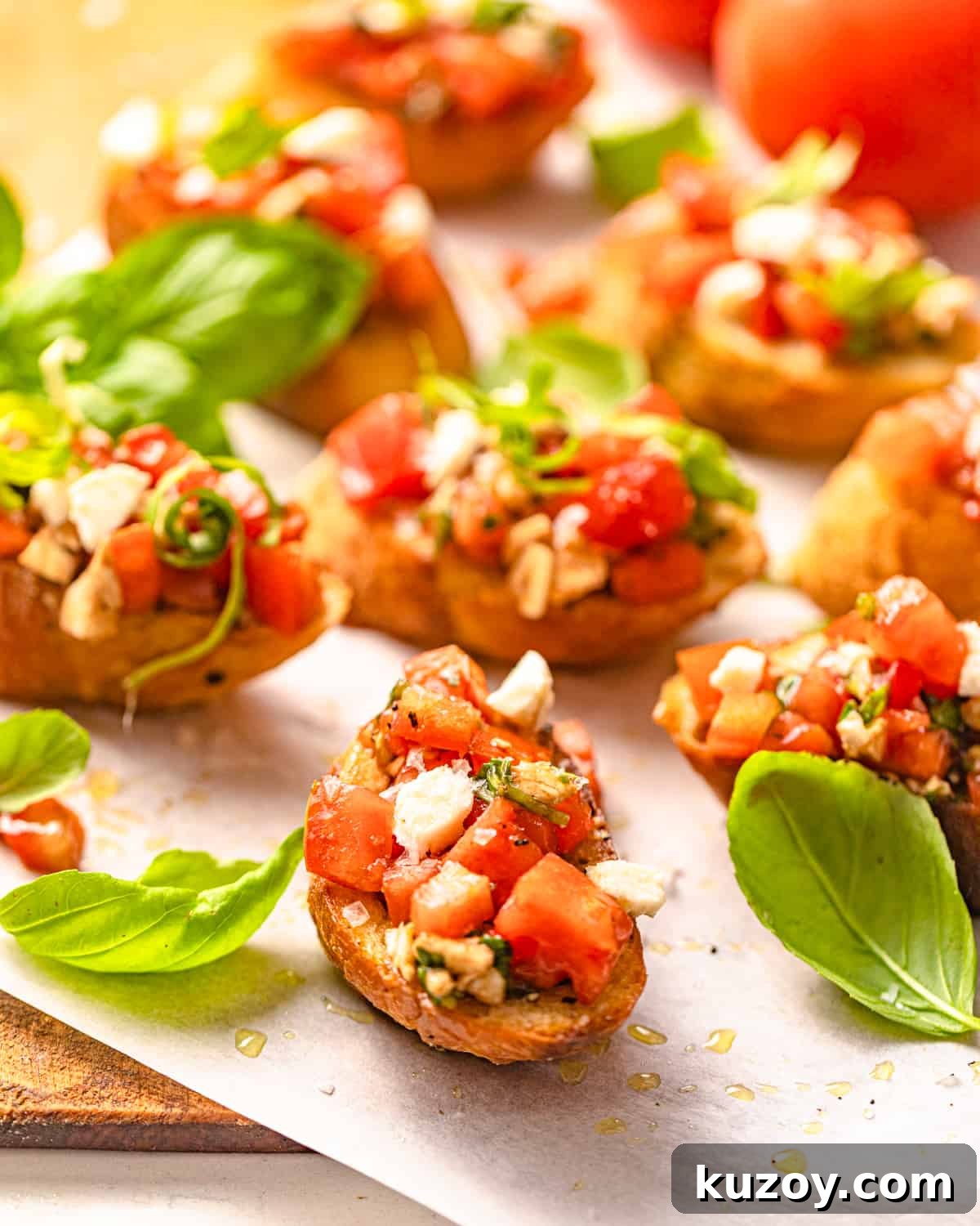 bruschetta with mozzarella topped with fresh basil on a wooden board.