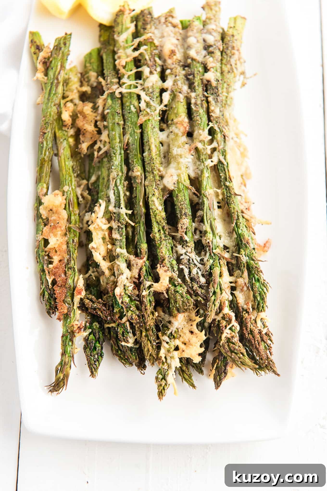 Crispy Air Fryer Asparagus Recipe with Garlic and Lemon 8 Air fryer asparagus seasoned and cooked on a plate.