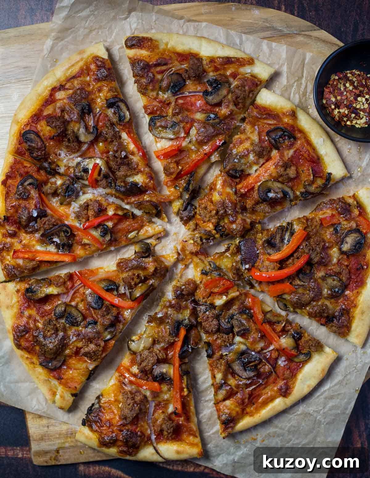 Sausage, mushroom, and peppers pizza cooked on a pellet grill