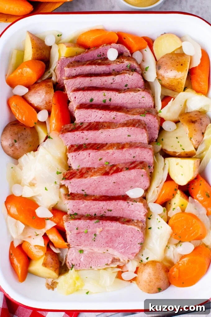 Dutch Oven Corned Beef Braised in Guinness 2 Overhead shot of tender corned beef served with veggies.