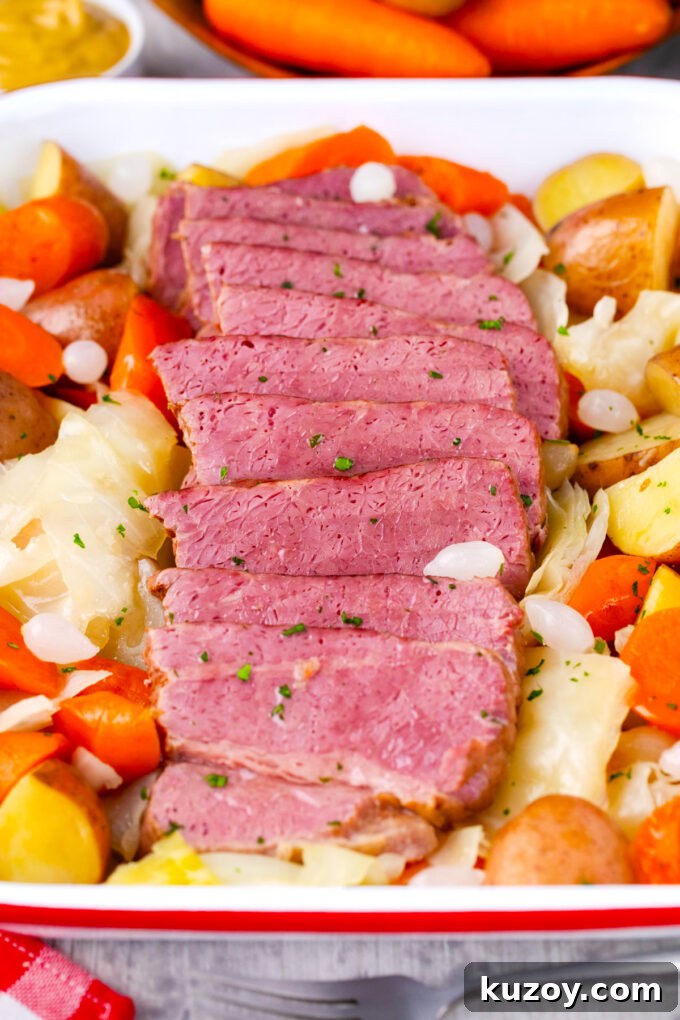 Dutch Oven Corned Beef Braised in Guinness 11 Overhead shot of tender corned beef served with carrots, cabbage, and potatoes.