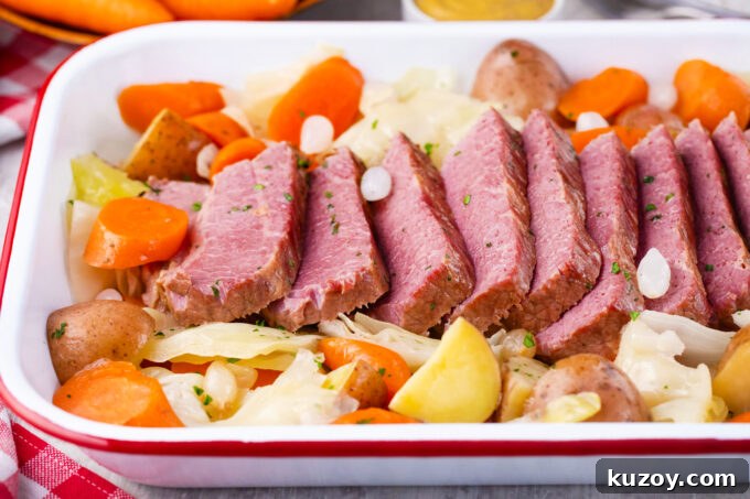 Dutch Oven Corned Beef Braised in Guinness 3 Sliced Dutch oven corned beef with cabbage, carrots, and potatoes.