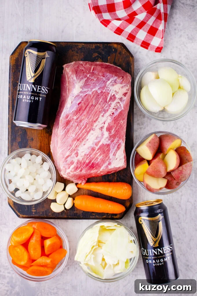Dutch Oven Corned Beef Braised in Guinness 4 Overhead shot of Dutch oven corned beef with Guinness beer ingredients arranged on a table.