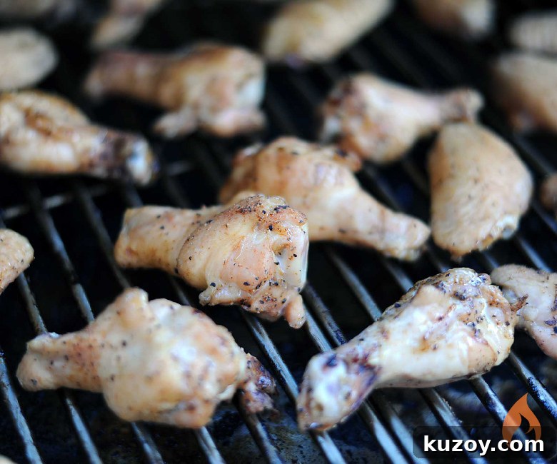 Tennessee Honey-Glazed Grilled Chicken Wings 3 chicken wings cooking on a grill