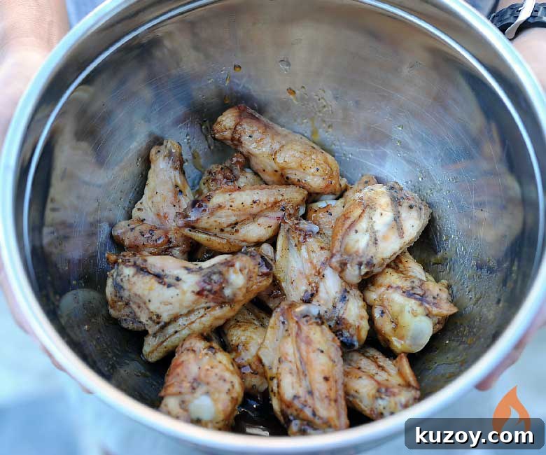 Tennessee Honey-Glazed Grilled Chicken Wings 4 wings in a bowl of sauce