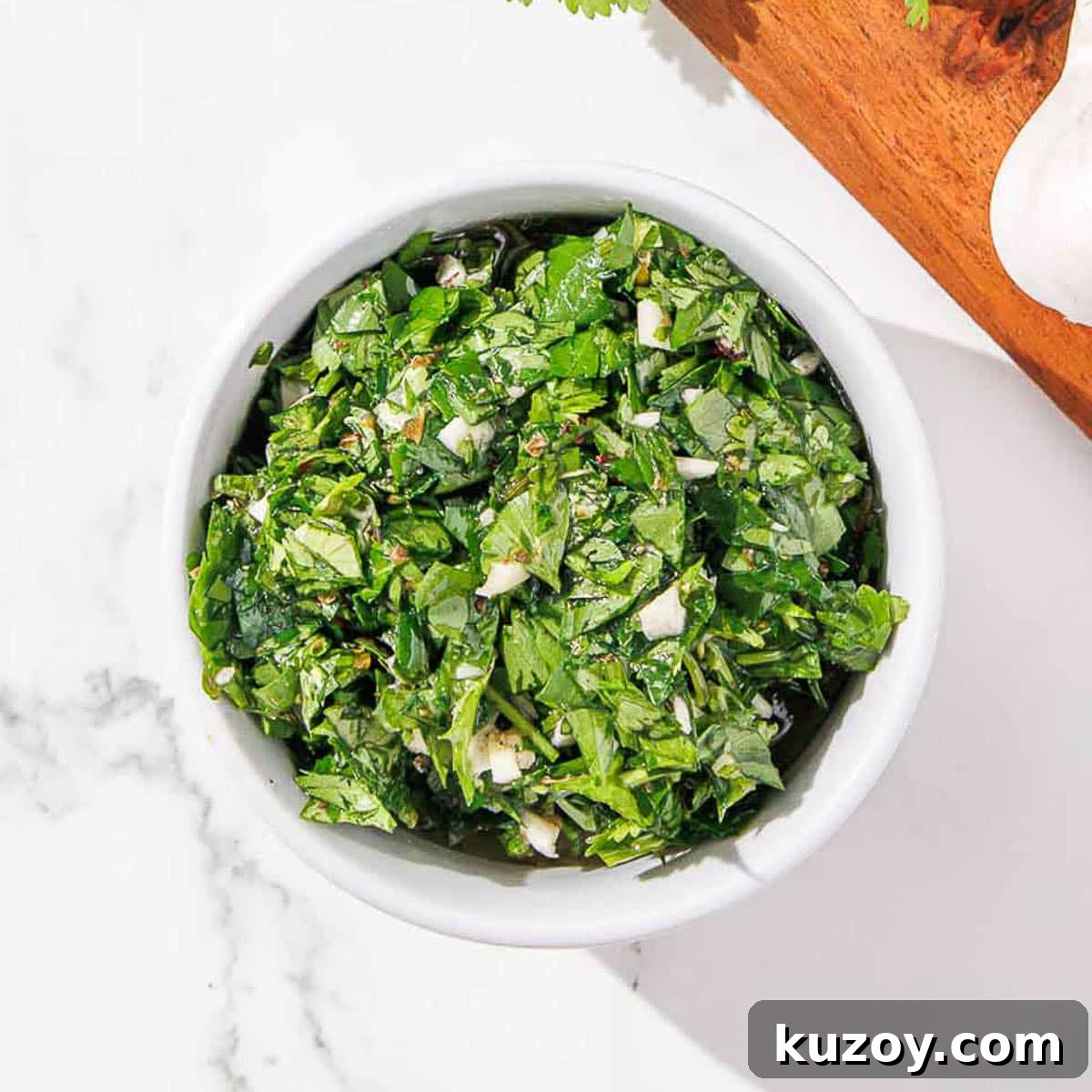 Finished cilantro chimichurri in a white ramekin.