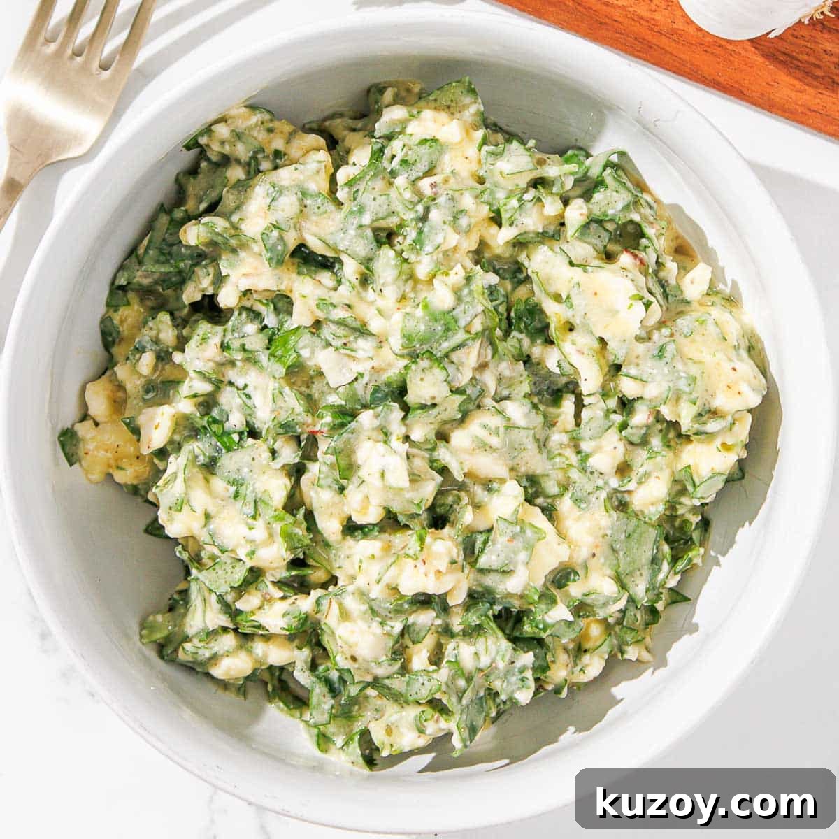 Butter combined with chimichurri in a dish.