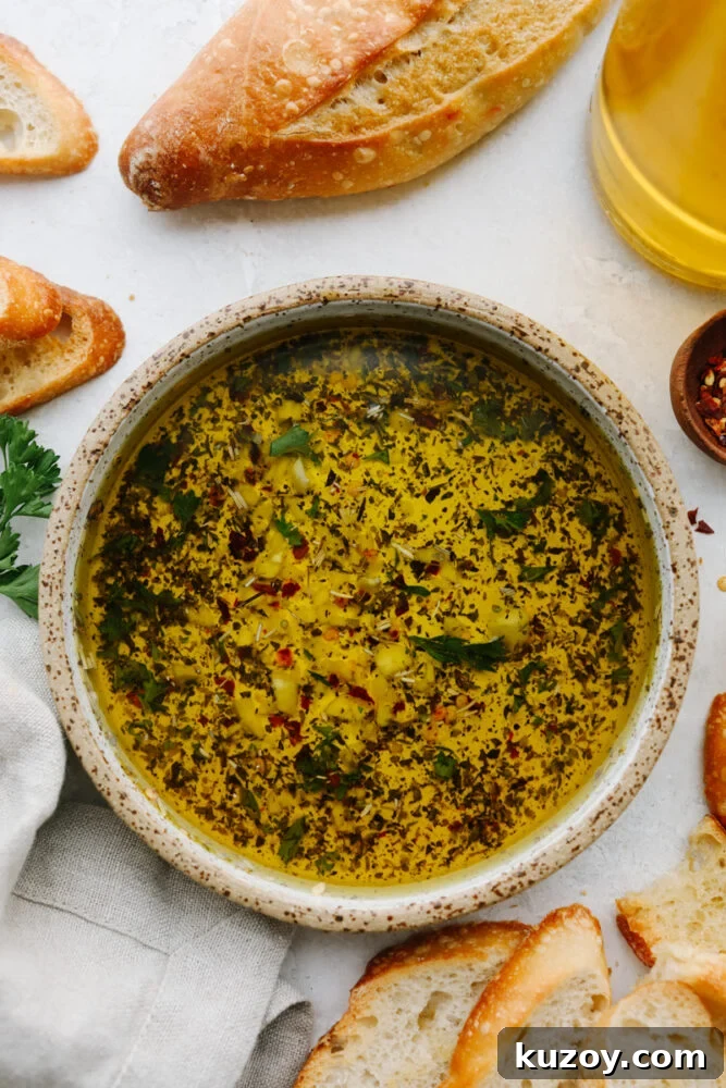 Olive oil bread dip A bowl of olive oil dip with bread next to it.