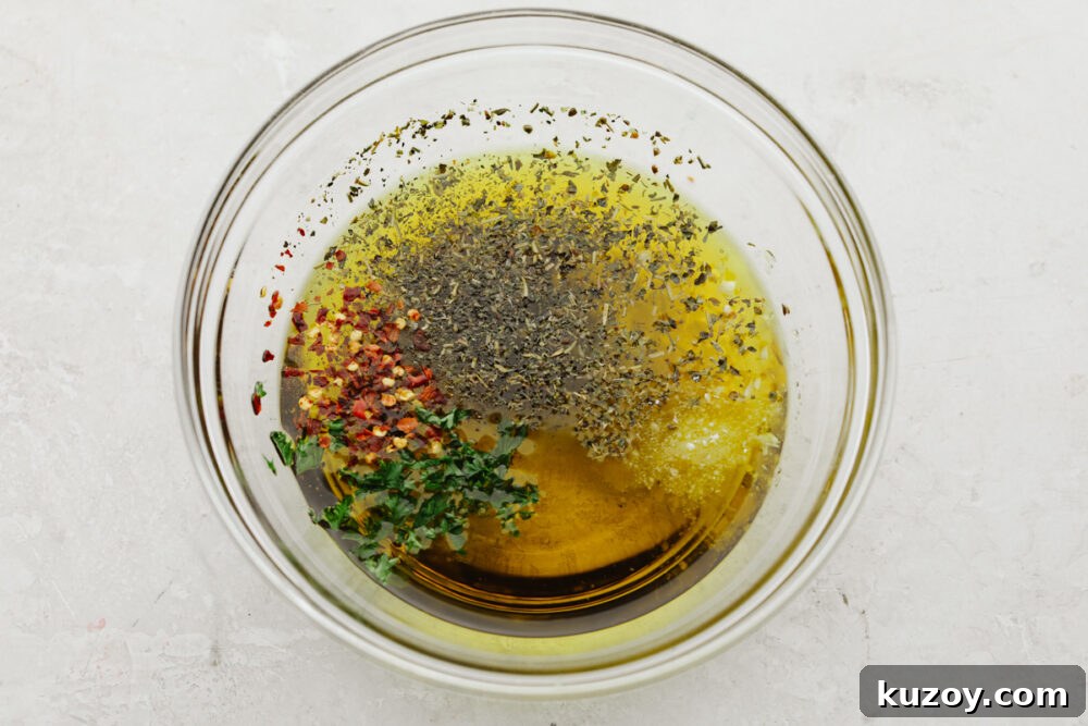 Mixing olive oil and spices A bowl with olive oil and spices being mixed.