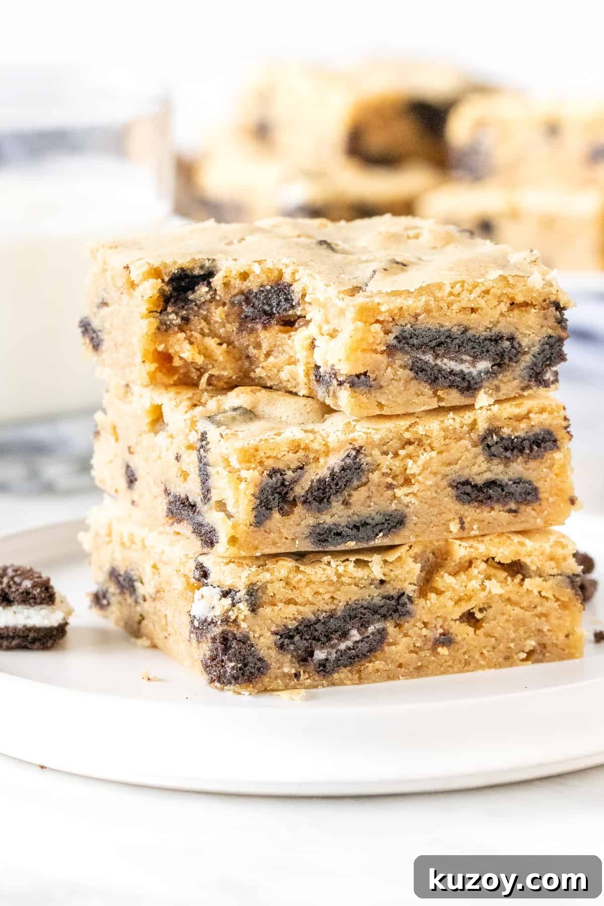 Oreo Blondies Recipe: Chewy Oreo-Stuffed Blondie Bars 6 Stack of Oreo blondies on a plate with a glass of milk
