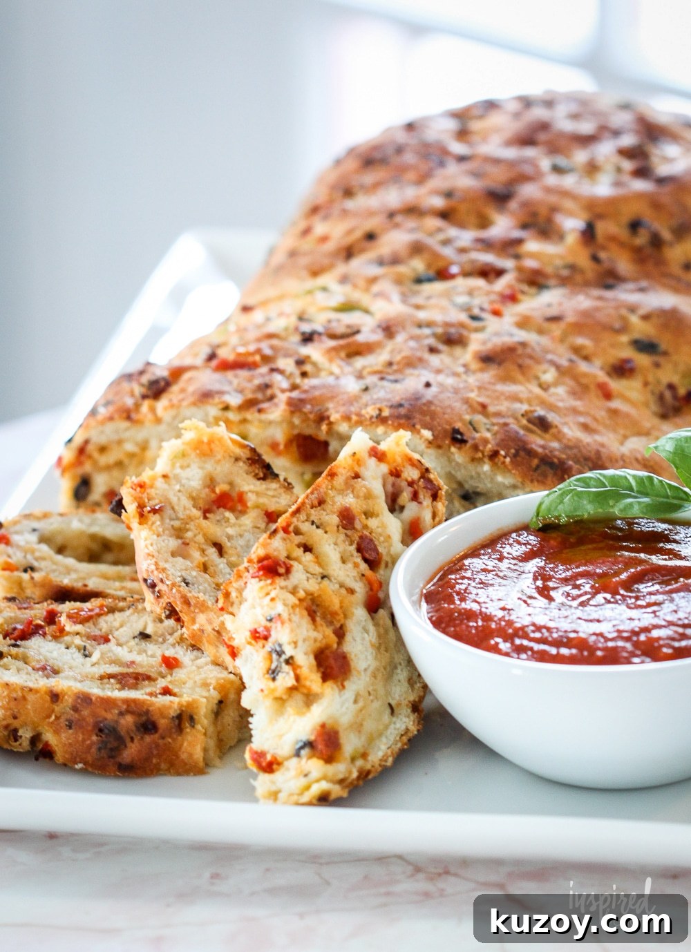 How to Make Homemade Pizza Bread (Crispy, Cheesy Recipe) 3 homemade pizza bread sliced and served with marinara sauce.