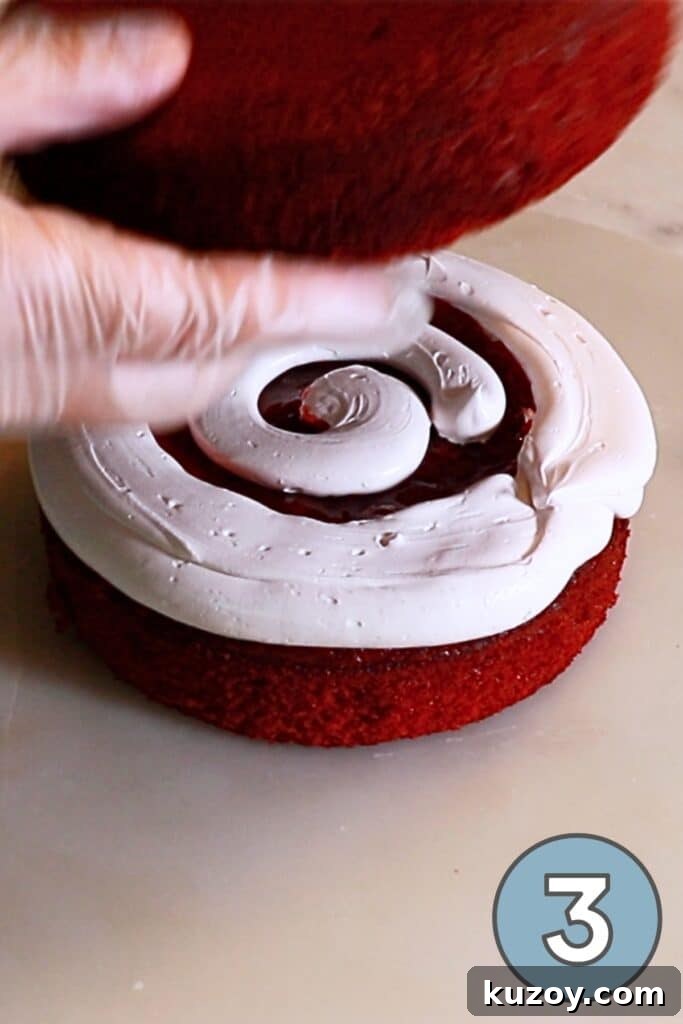 Vintage Pink Cake Ideas for Elegant Party Desserts 11 placing the second layer of red velvet cake on top