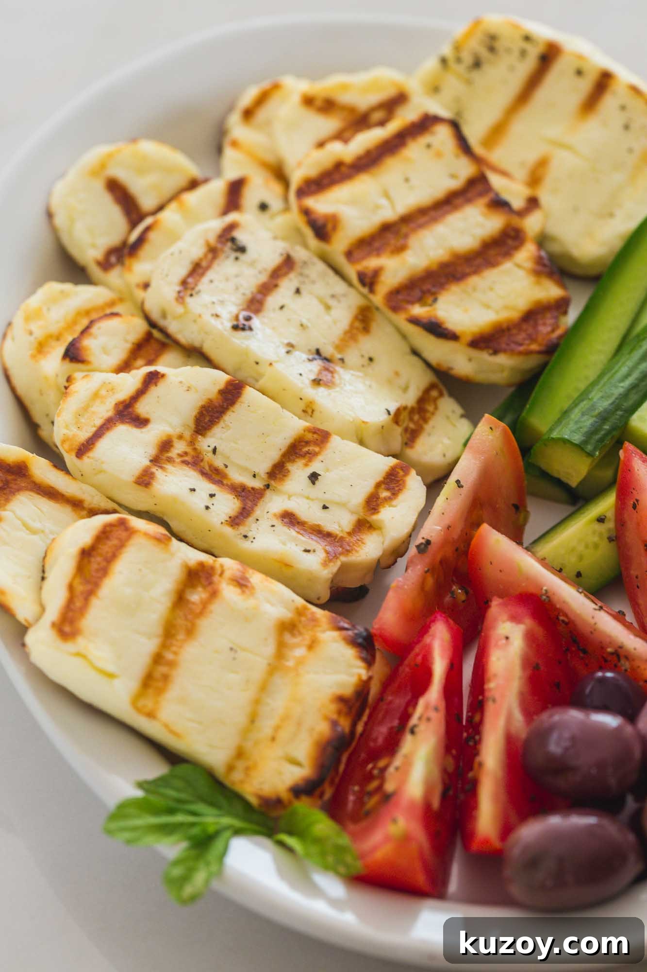 How to Grill Halloumi Perfectly for Crispy, Squeaky Cheese 5 An angle shot of the halloumi platter with grilled halloumi and fresh cut vegetables