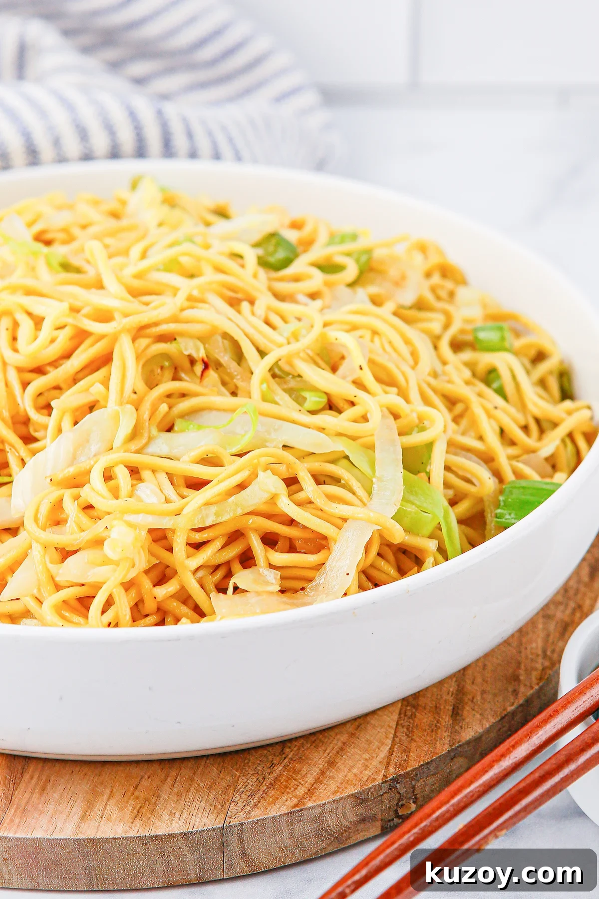 Panda Express Chow Mein Recipe: Copycat Version for Home Cooking 7 Close up of a white serving bowl filled with homemade Panda Express Chow Mein noodles.