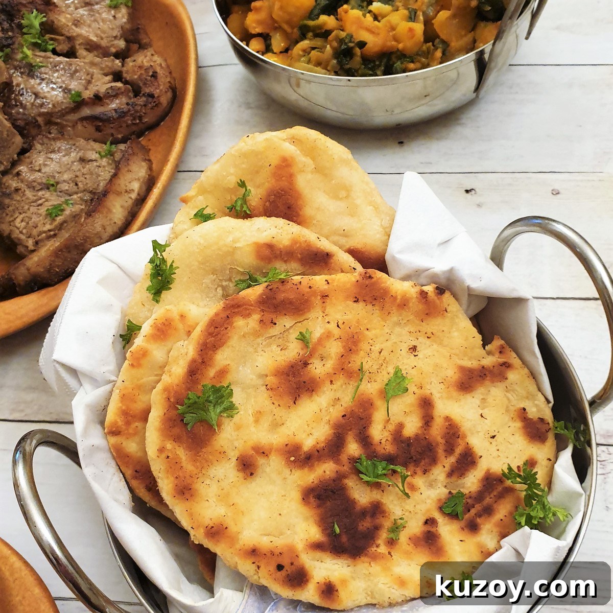 A balti dish filled with buttery garlic naan bread.