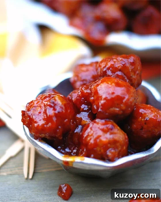 A bowl of spicy whiskey Peach BBQ meatballs for a party.