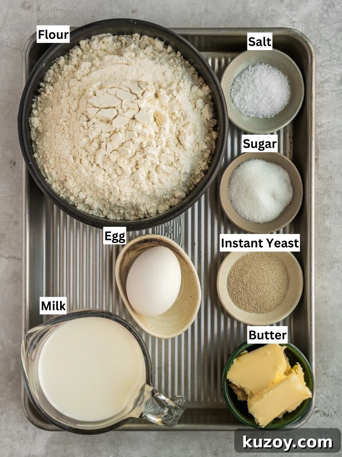 Soft, Buttery Double-Crust Dinner Rolls 4 Double cheeked buns recipe ingredients with individual labels on a metal tray.
