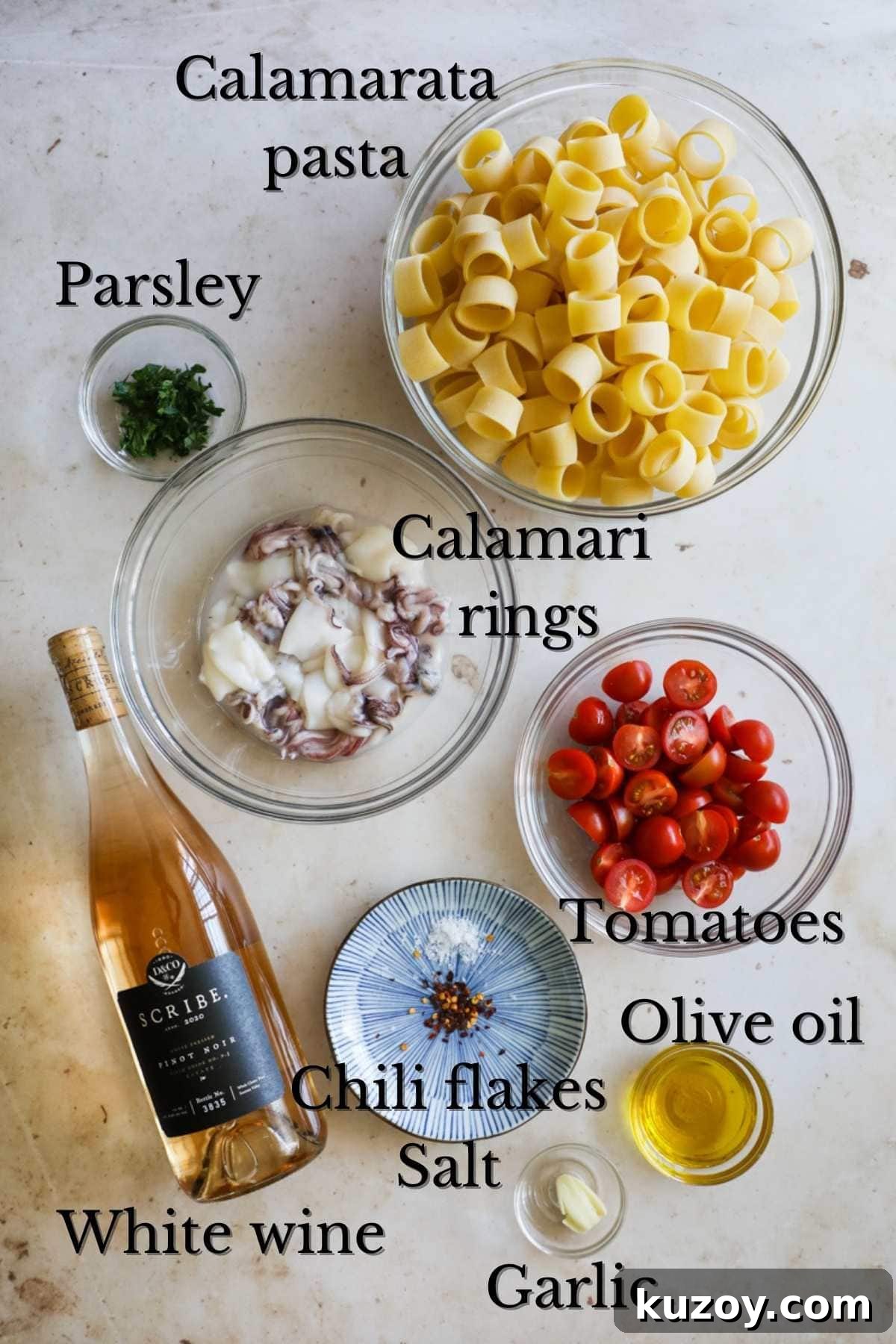 Ingredients to make Calamarata (calamari and tomato) pasta.