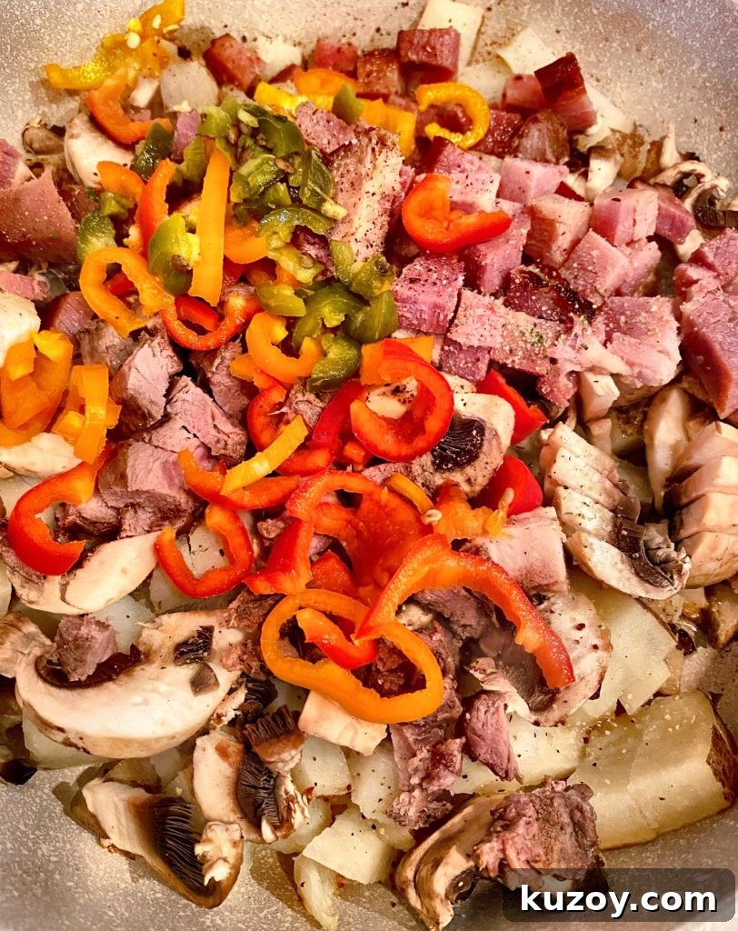 Country Skillet Breakfast Scramble with Sausage & Potatoes 3 Skillet ingredients, peppers, potatoes, meats, etc. in a large skillet over medium heat.