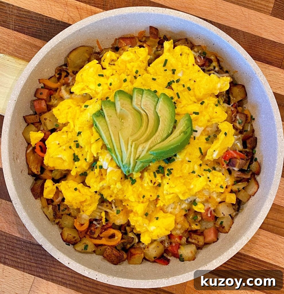 Country Skillet Breakfast Scramble with Sausage & Potatoes 6 Skillet Breakfast in the skillet on top of a cutting board.